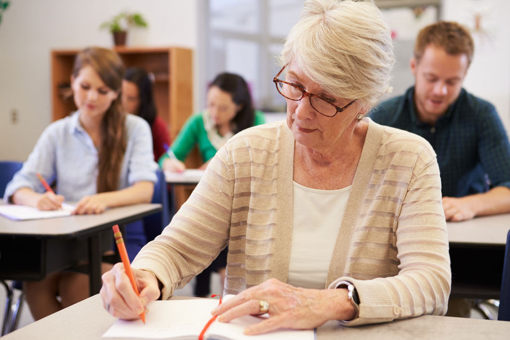 senior-woman-studying-at-an-adult-education-class-PS8AGN7